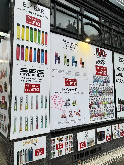 Image of a UK vape shop showcasing a variety of e-liquid and disposable vape brands with promotional offers, highlighting the competitive retail environment.